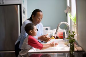 Grandma and grandson doing dishes